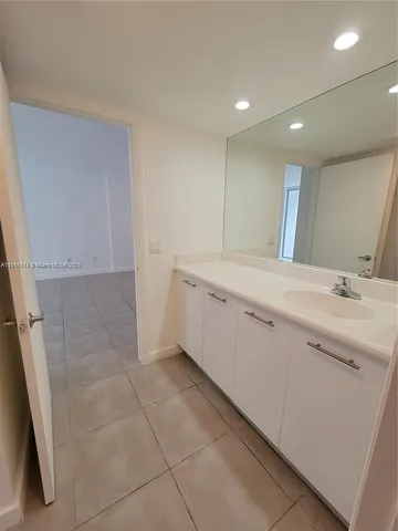 a view of a bathroom with a sink and mirror