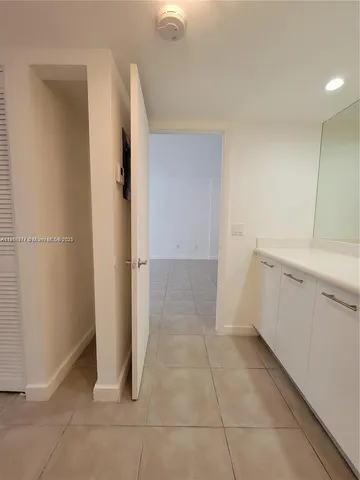 a view of a kitchen with white cabinets