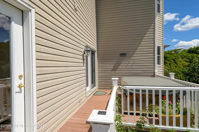 a kitchen with stainless steel appliances granite countertop a dining table chairs refrigerator sink and cabinets