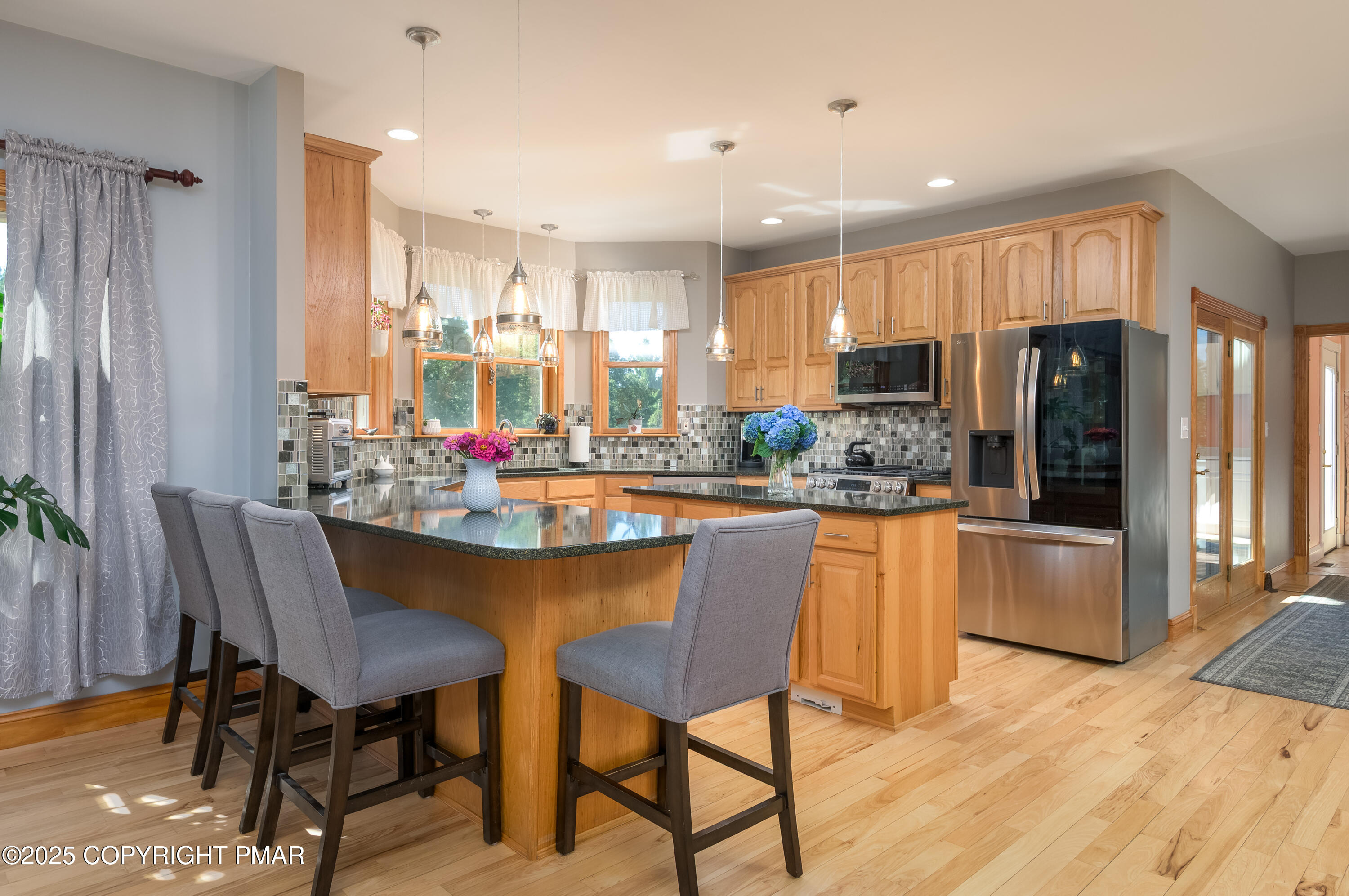 150 Red Oak Drive Palmerton, PA 18071 - Photo 28 of 76 a kitchen with stainless steel appliances granite countertop a dining table chairs refrigerator sink and cabinets