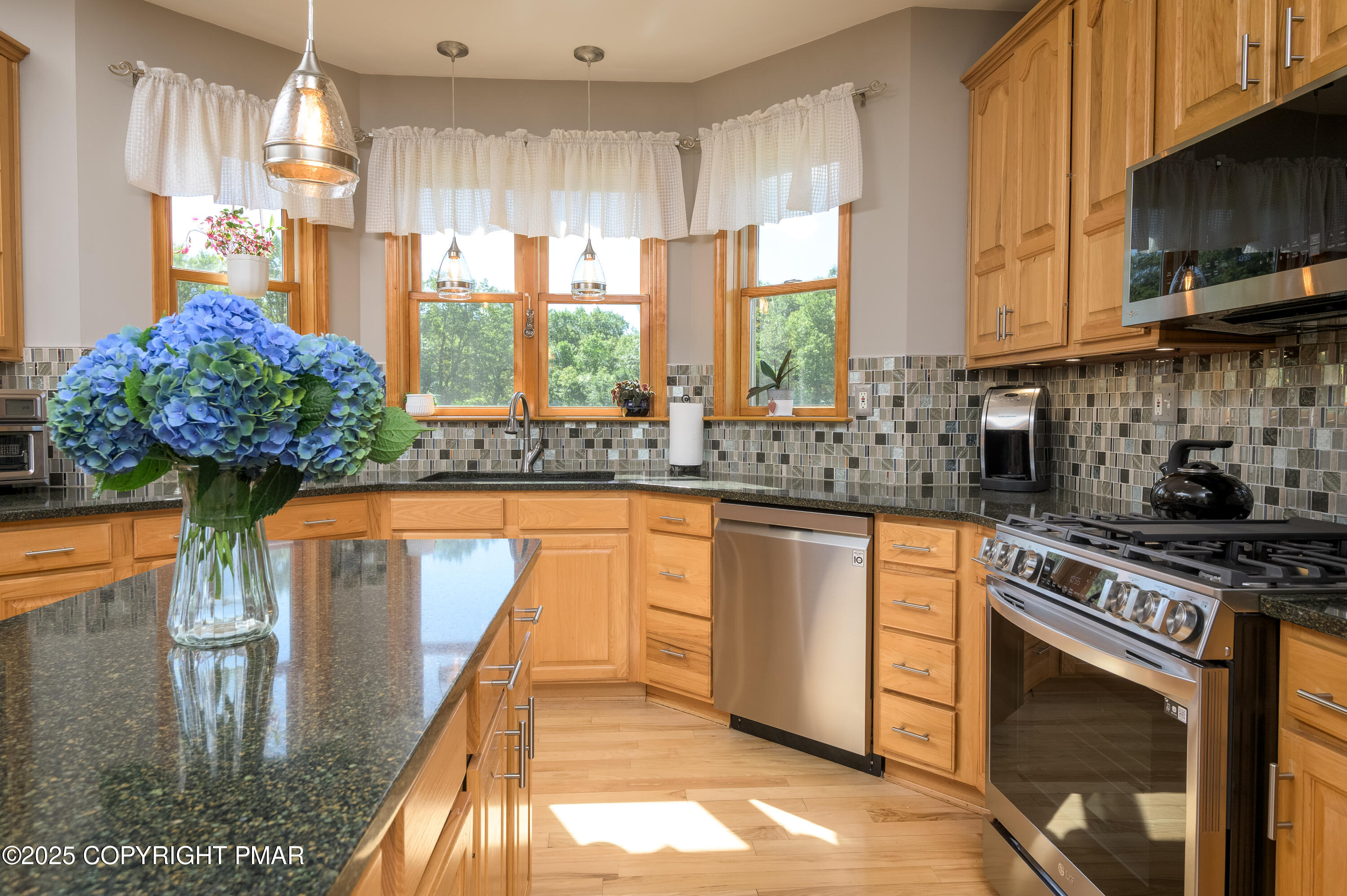 150 Red Oak Drive Palmerton, PA 18071 - Photo 29 of 76 a kitchen with stainless steel appliances granite countertop a stove a sink and a microwave