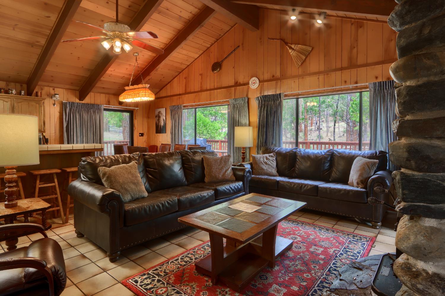 8041 Chilnualna Falls Road Wawona, CA 95389 - Photo 3 of 46 a living room with furniture a ceiling fan and a window