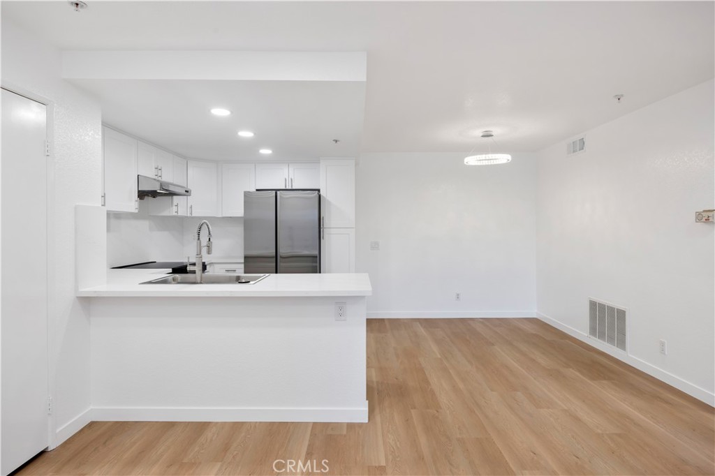 a view of a kitchen with wooden floor