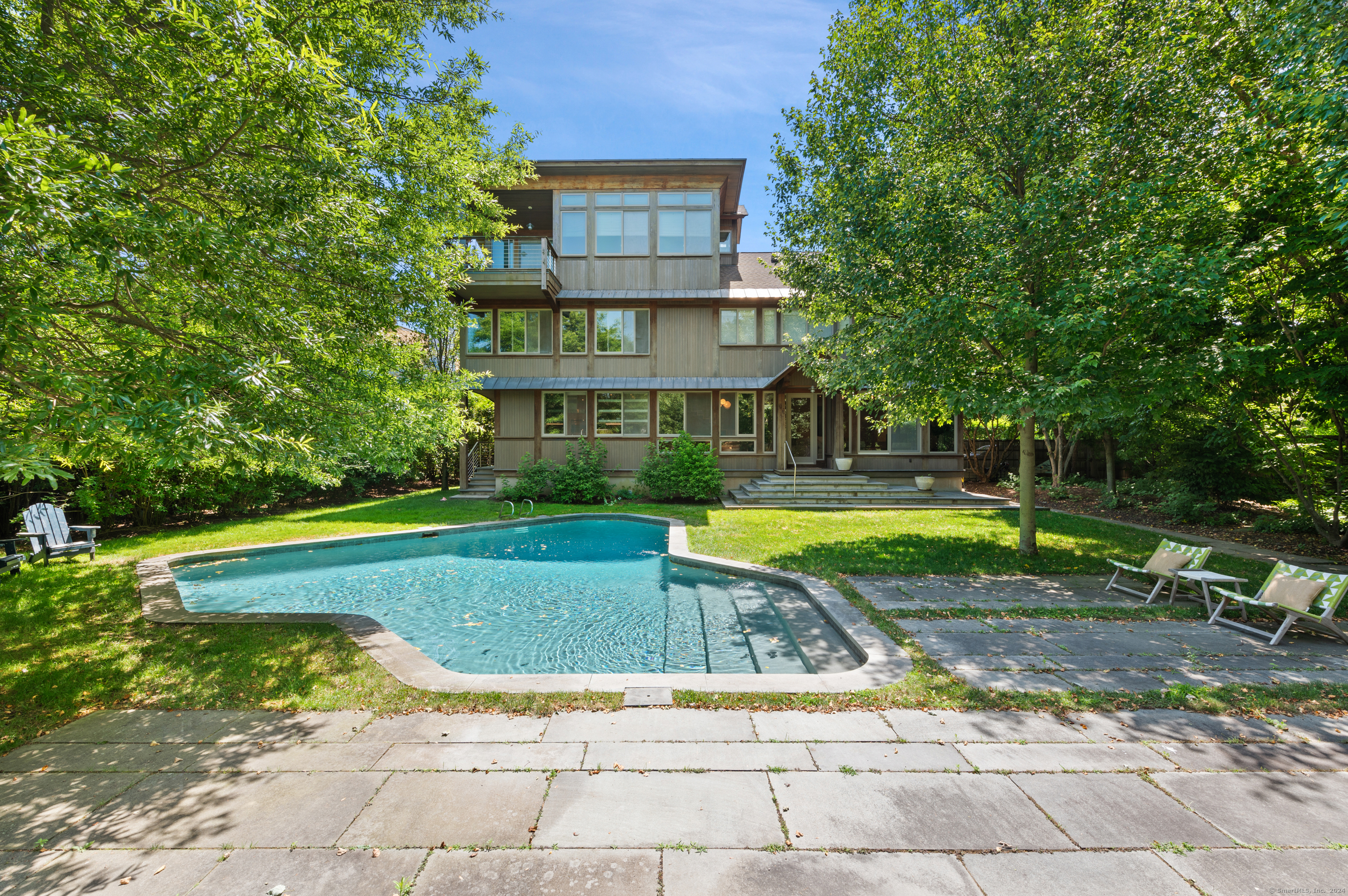 a view of a house with swimming pool and sitting area
