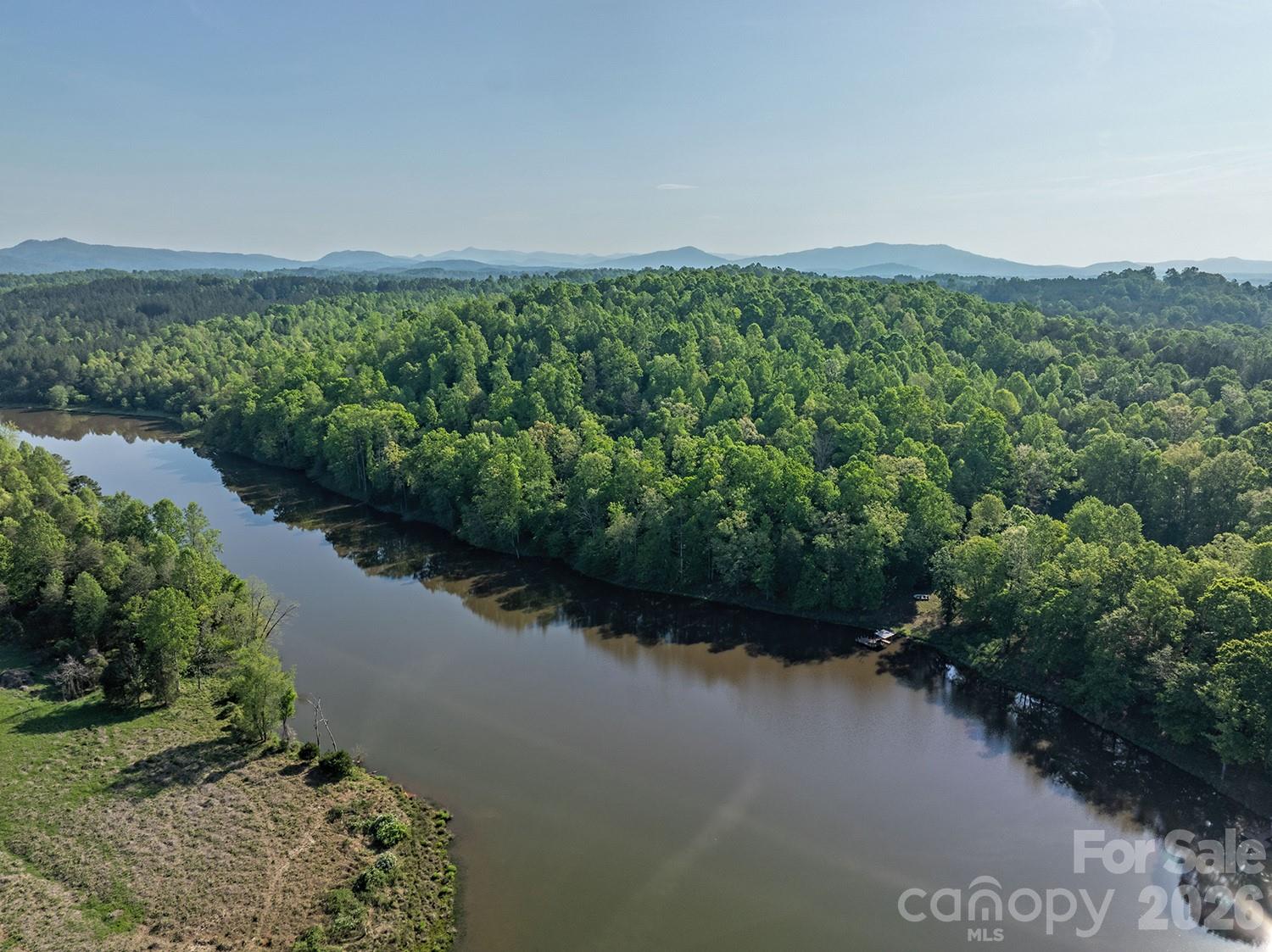 5555 Groves Road Union Mills, NC 28167 - Photo 8 of 26 a view of a lake with a field