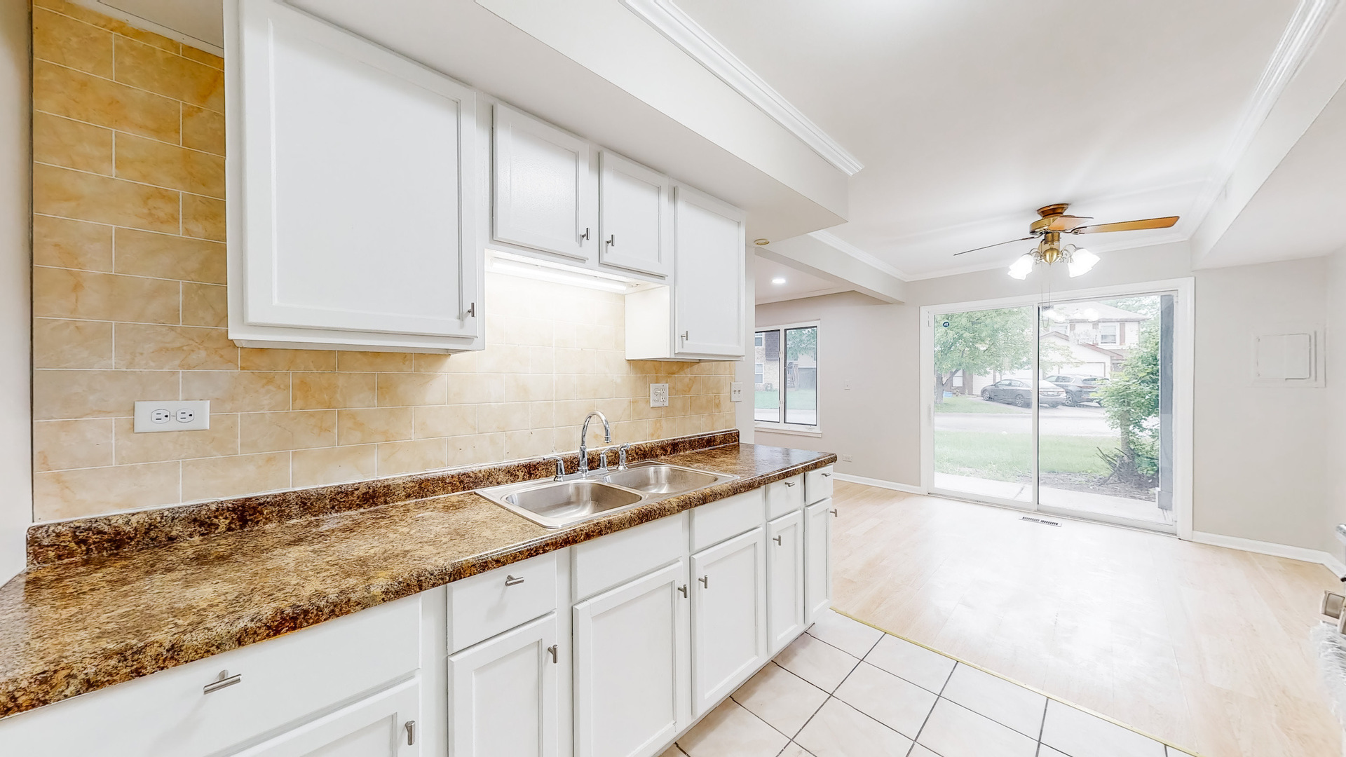 20 Elm Court, Unit 3 Bolingbrook, IL 60440 - Photo 12 of 21 a kitchen with granite countertop a sink and white cabinets