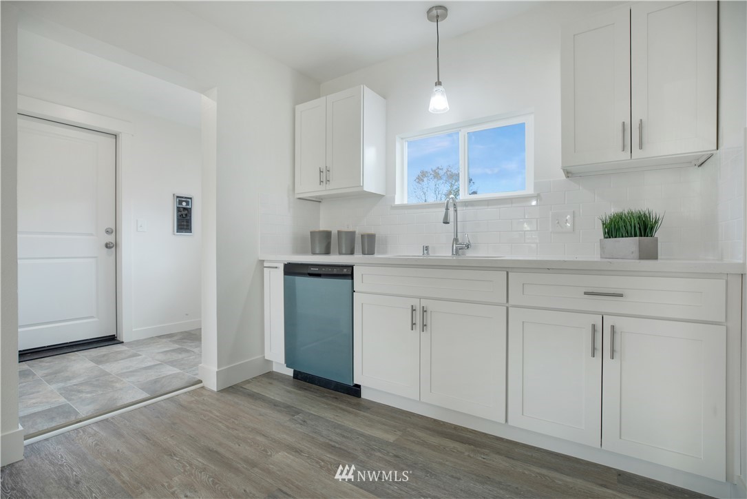 314 3rd Street Roy, WA 98580 - Photo 11 of 30 a kitchen with stainless steel appliances granite countertop a sink a stove a refrigerator and white cabinets