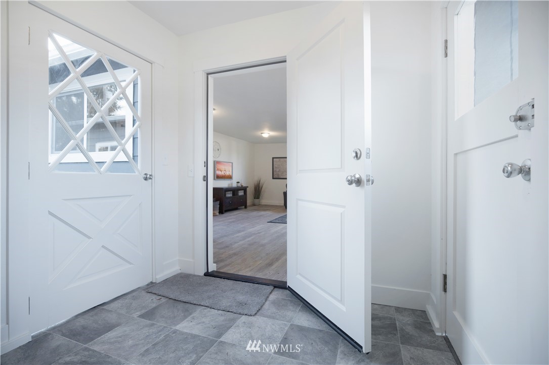 314 3rd Street Roy, WA 98580 - Photo 13 of 30 a view of a hallway with wooden floor and a bathroom