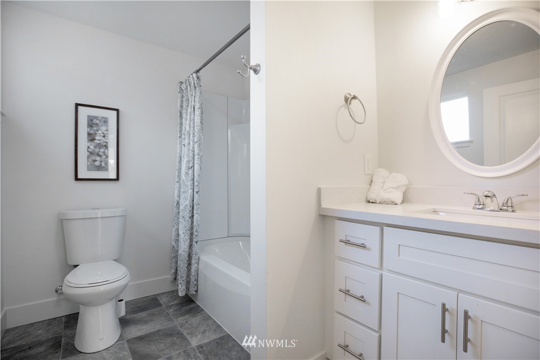 314 3rd Street Roy, WA 98580 - Photo 21 of 30 a bathroom with a toilet sink and mirror