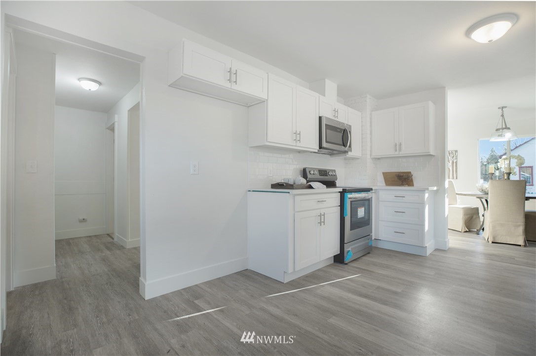 314 3rd Street Roy, WA 98580 - Photo 10 of 30 a kitchen with cabinets and wooden floor