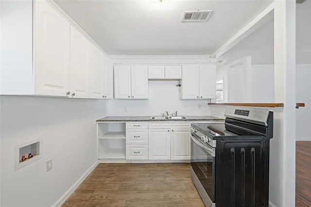 a kitchen with stainless steel appliances granite countertop a stove and a refrigerator
