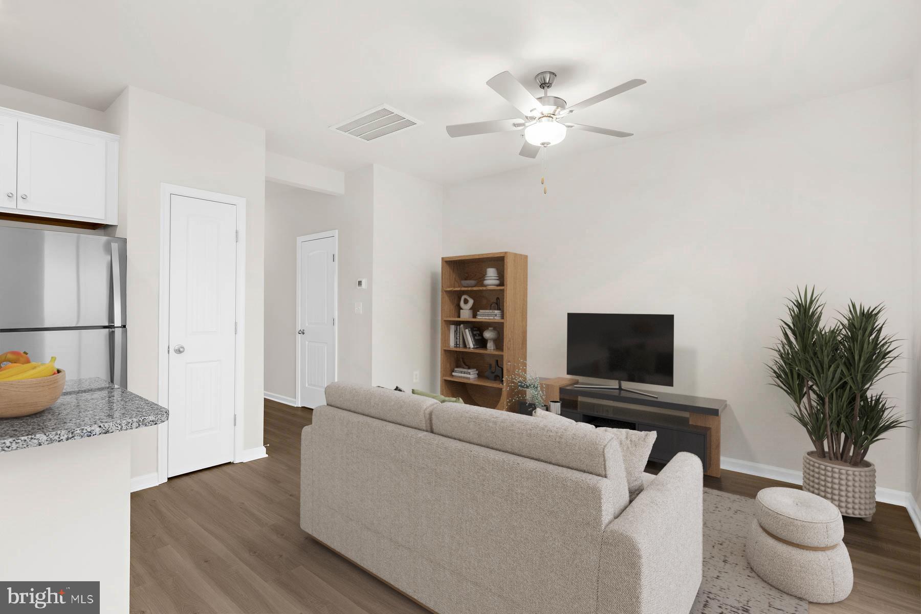 8126 Bartholomew Court Baltimore, MD 21206 - Photo 9 of 14 a living room with furniture and a flat screen tv
