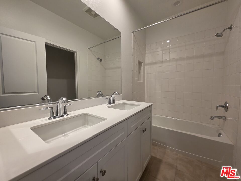 5308 Harvard Way Cypress, CA 90630 - Photo 9 of 17 a bathroom with a sink double vanity granite tub shower and a mirror