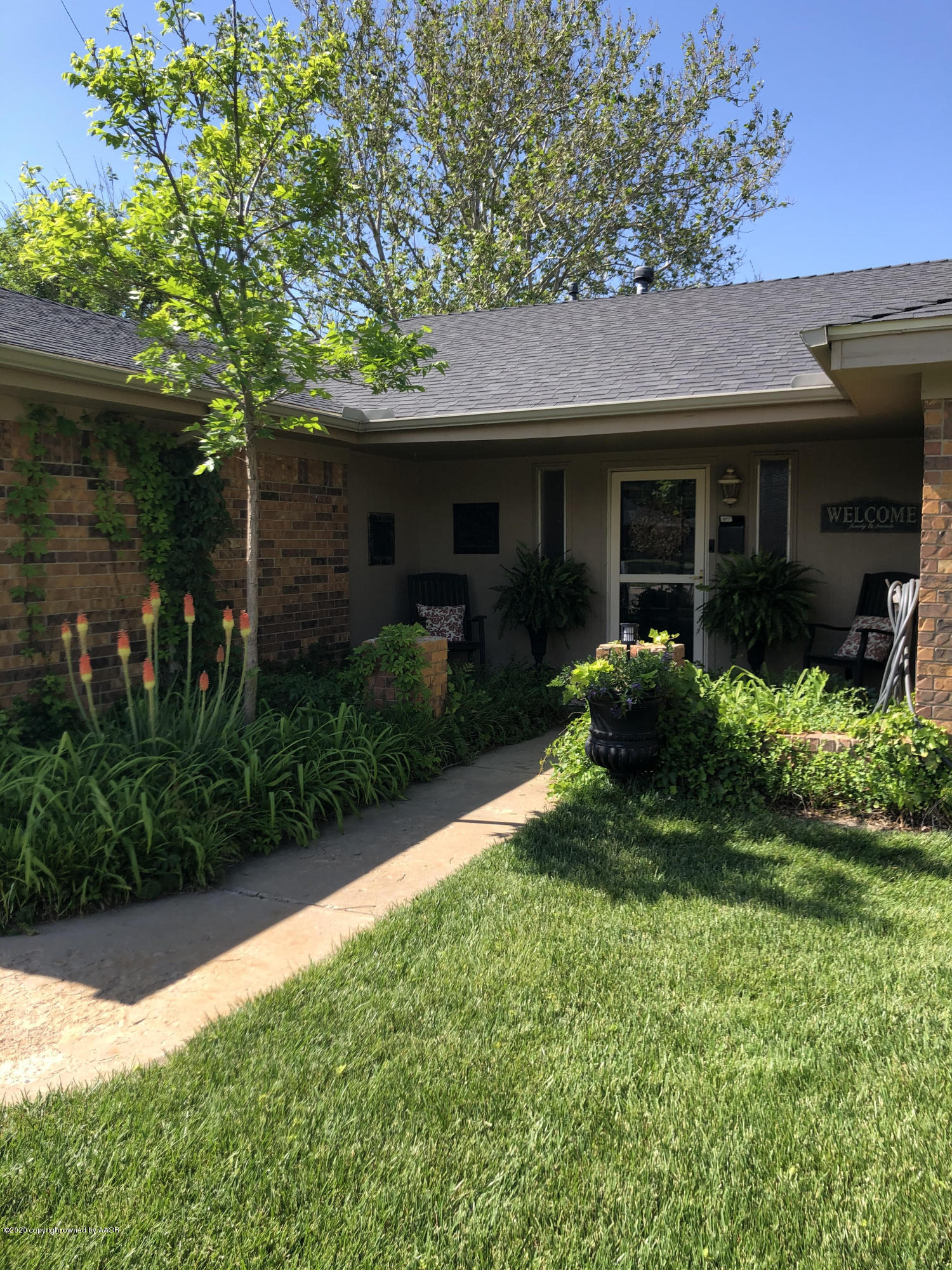 6012 Gainsborough Road Amarillo, TX 79106 - Photo 2 of 15 a front view of a house with a yard and porch