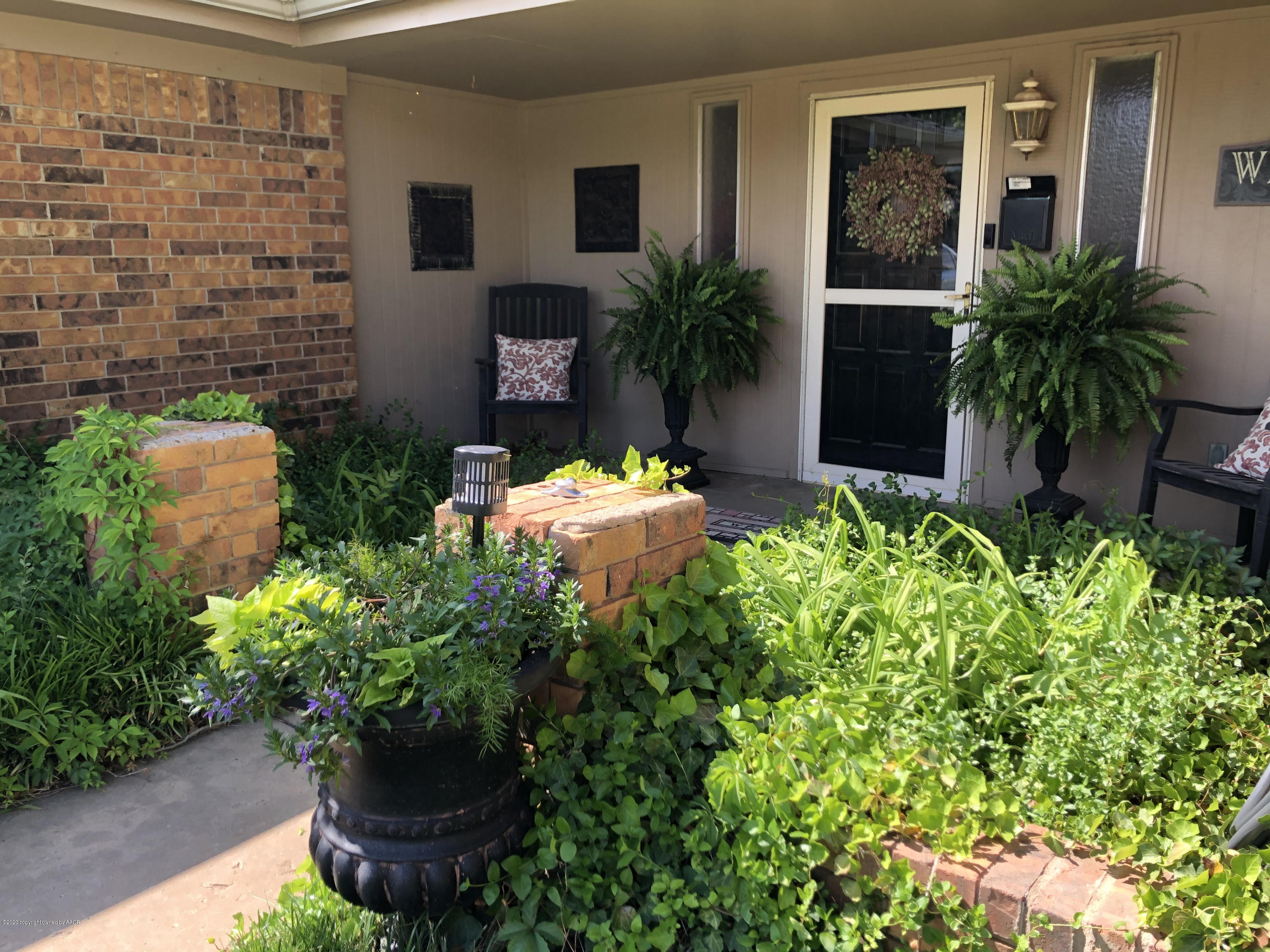 6012 Gainsborough Road Amarillo, TX 79106 - Photo 3 of 15 a potted plant sitting in front of a house