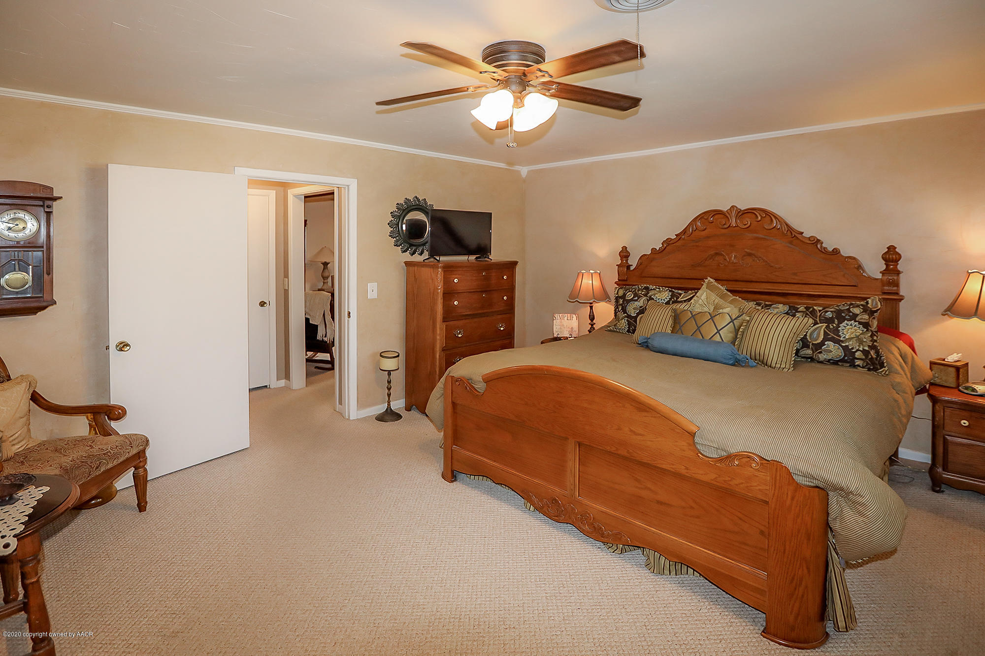 6012 Gainsborough Road Amarillo, TX 79106 - Photo 9 of 15 a spacious bedroom with a bed and a chandelier