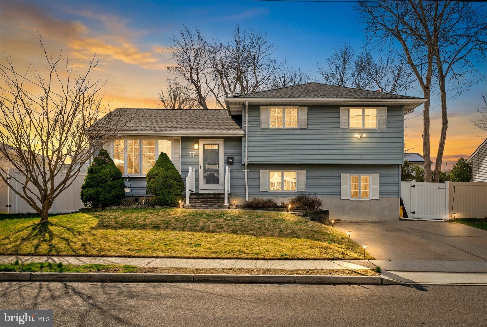 77 Gary Drive Hamilton, NJ 08690 - Photo 1 of 26 a front view of a house with a yard