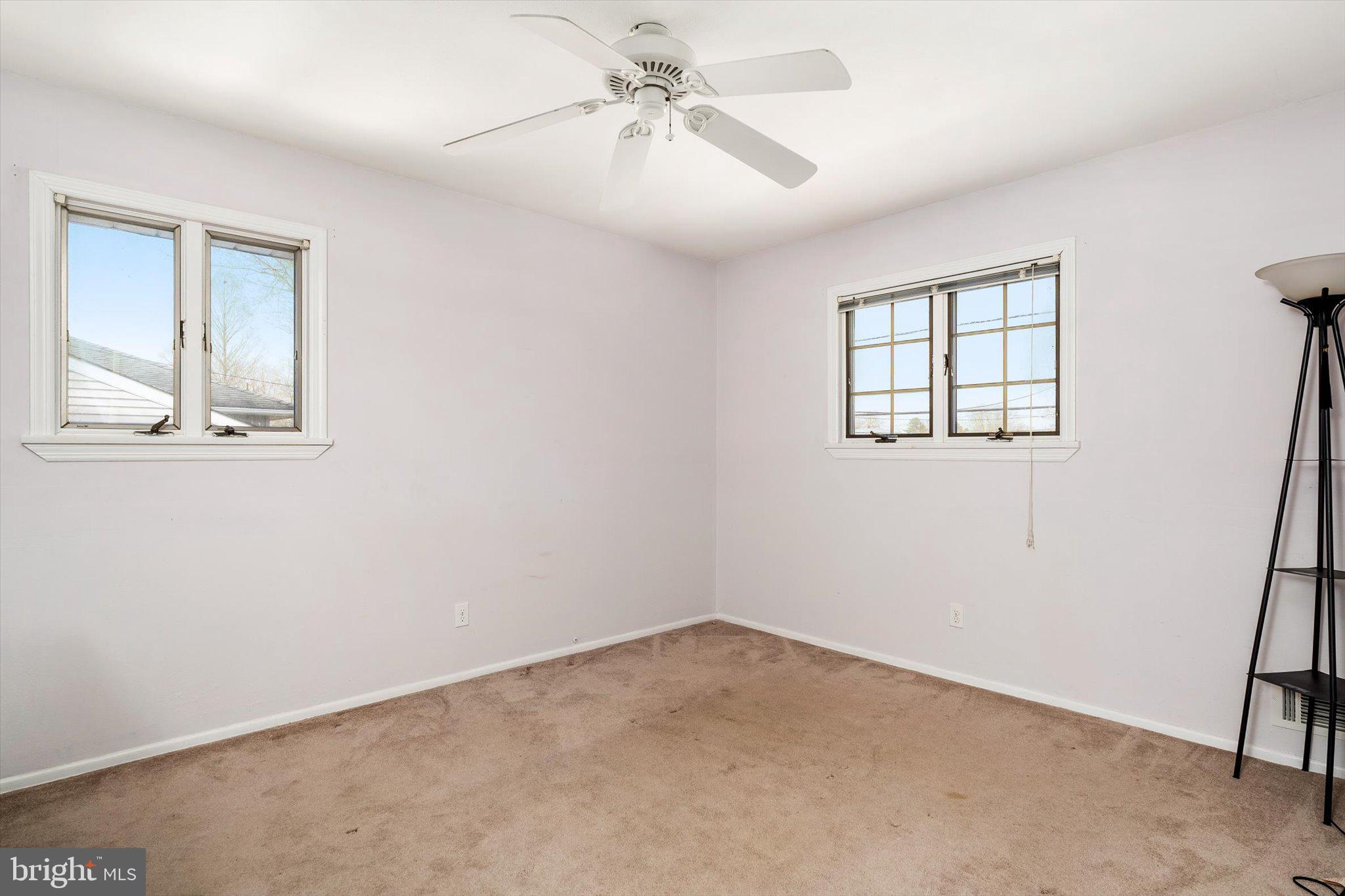 77 Gary Drive Hamilton, NJ 08690 - Photo 11 of 26 an empty room with windows and fan