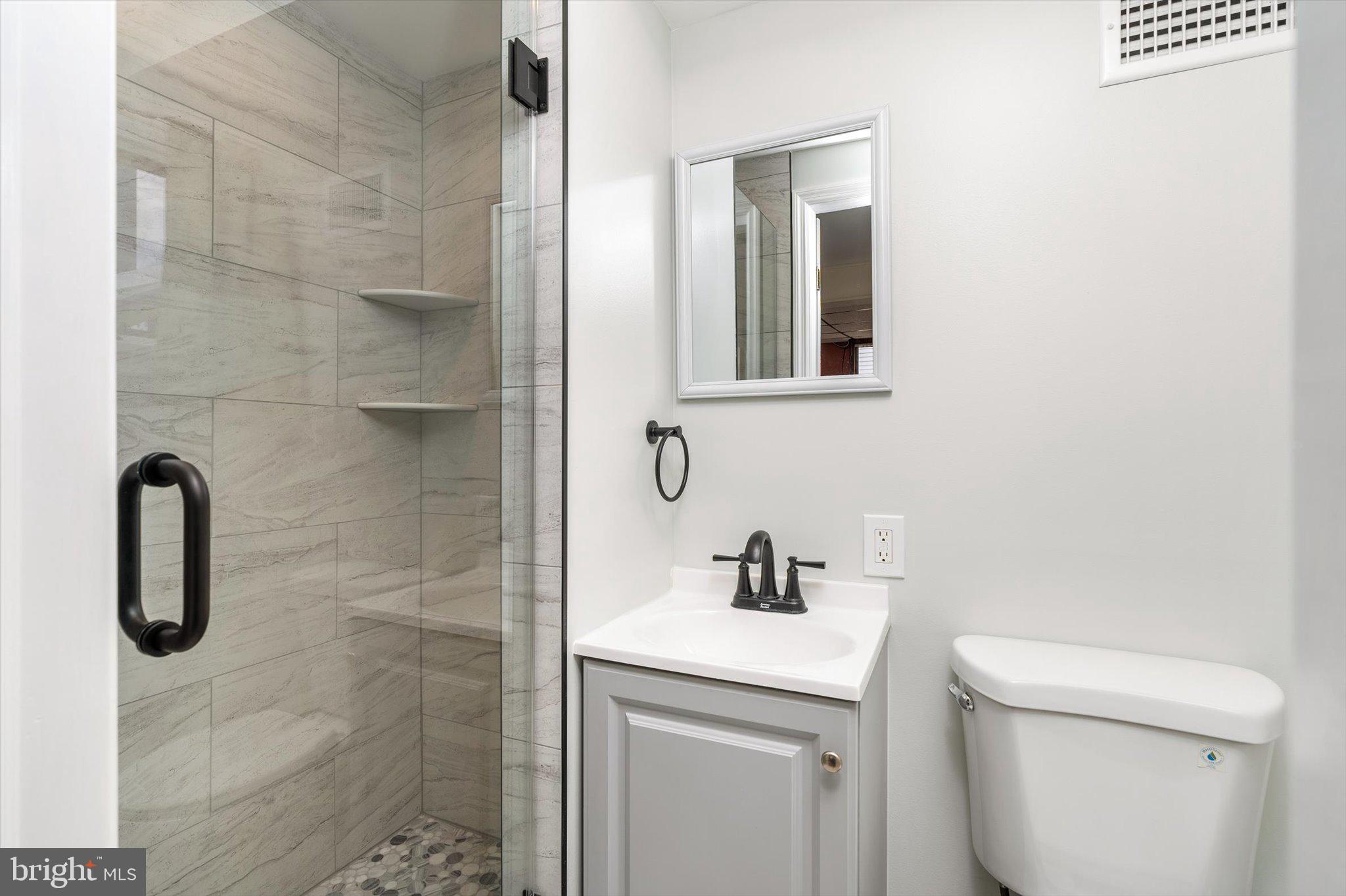 77 Gary Drive Hamilton, NJ 08690 - Photo 15 of 26 a bathroom with a sink a toilet and shower