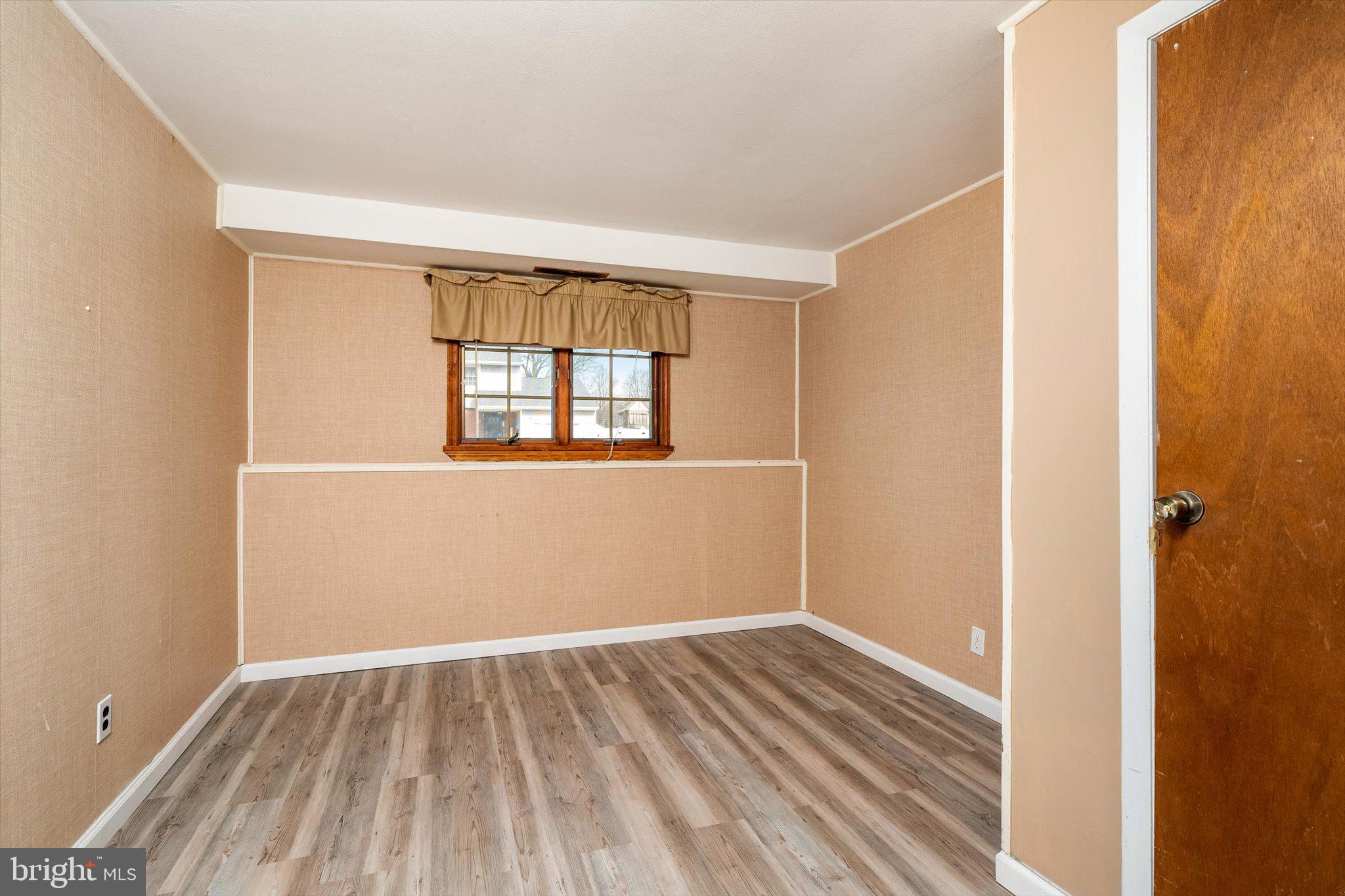 77 Gary Drive Hamilton, NJ 08690 - Photo 19 of 26 an empty room with wooden floor and windows