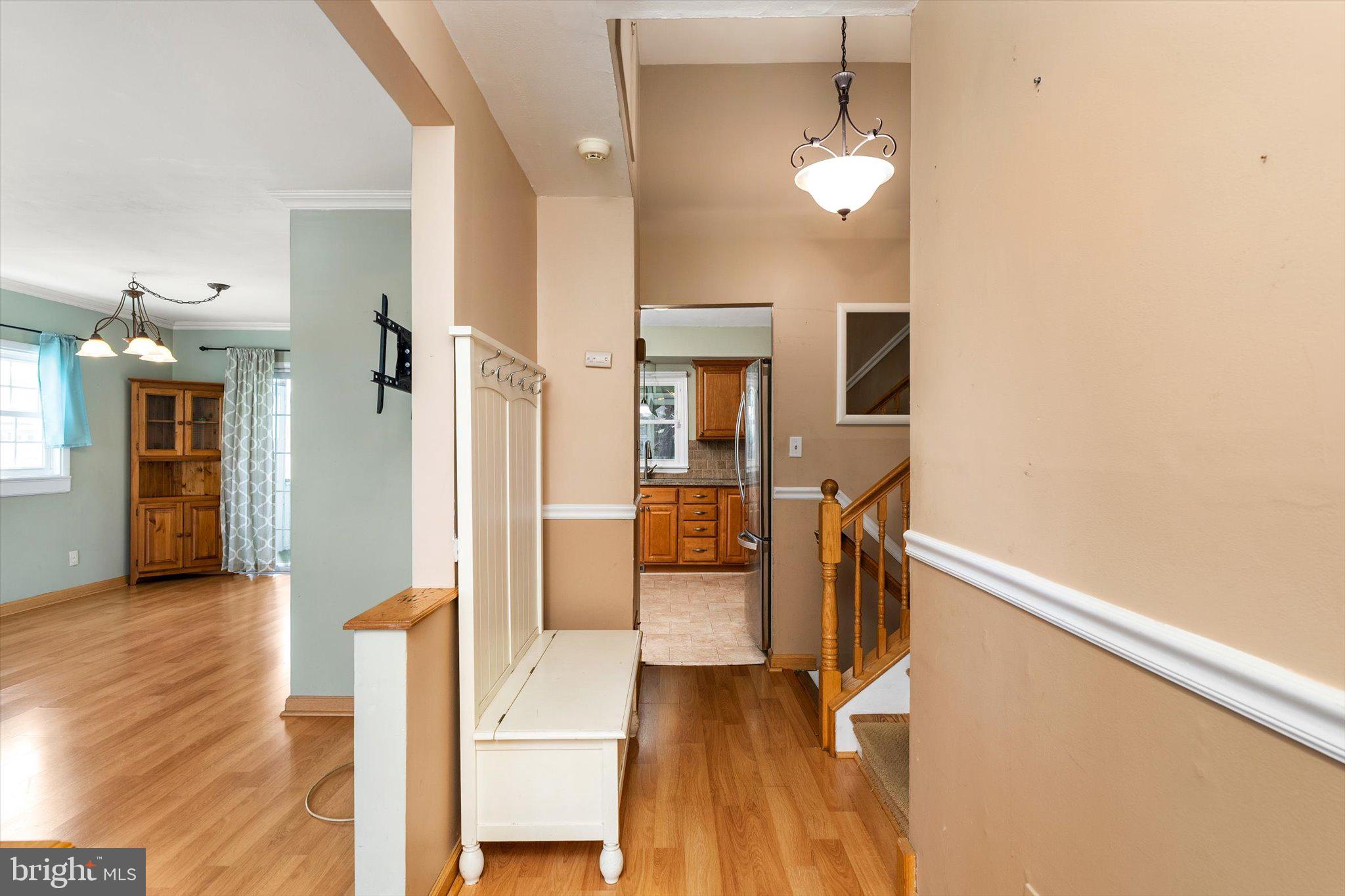 77 Gary Drive Hamilton, NJ 08690 - Photo 2 of 26 a view of a hallway with wooden floor windows and a chandelier