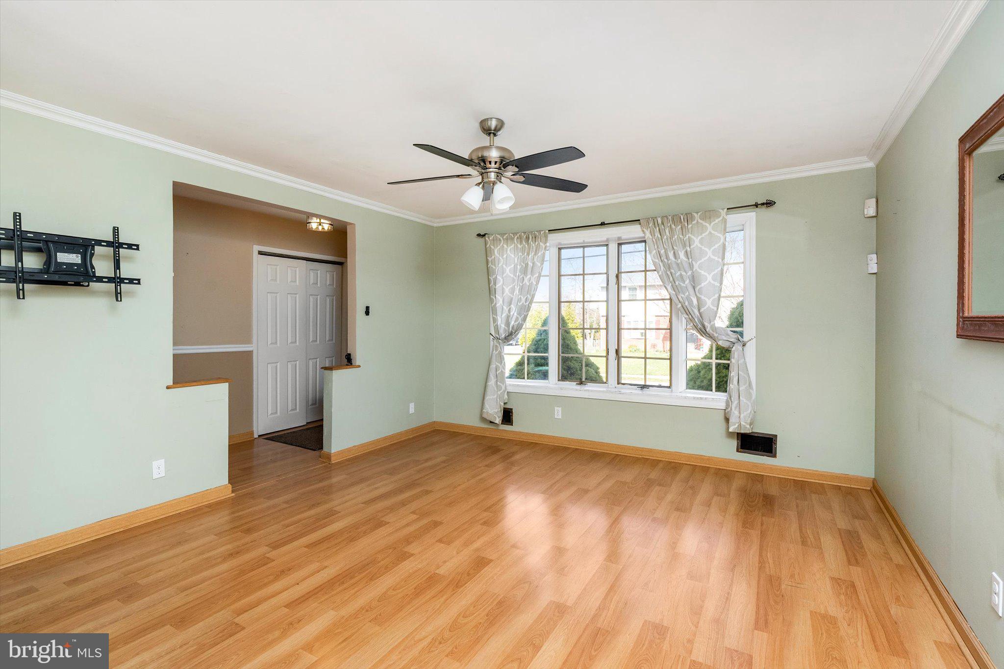 77 Gary Drive Hamilton, NJ 08690 - Photo 3 of 26 a view of empty room with wooden floor and fan