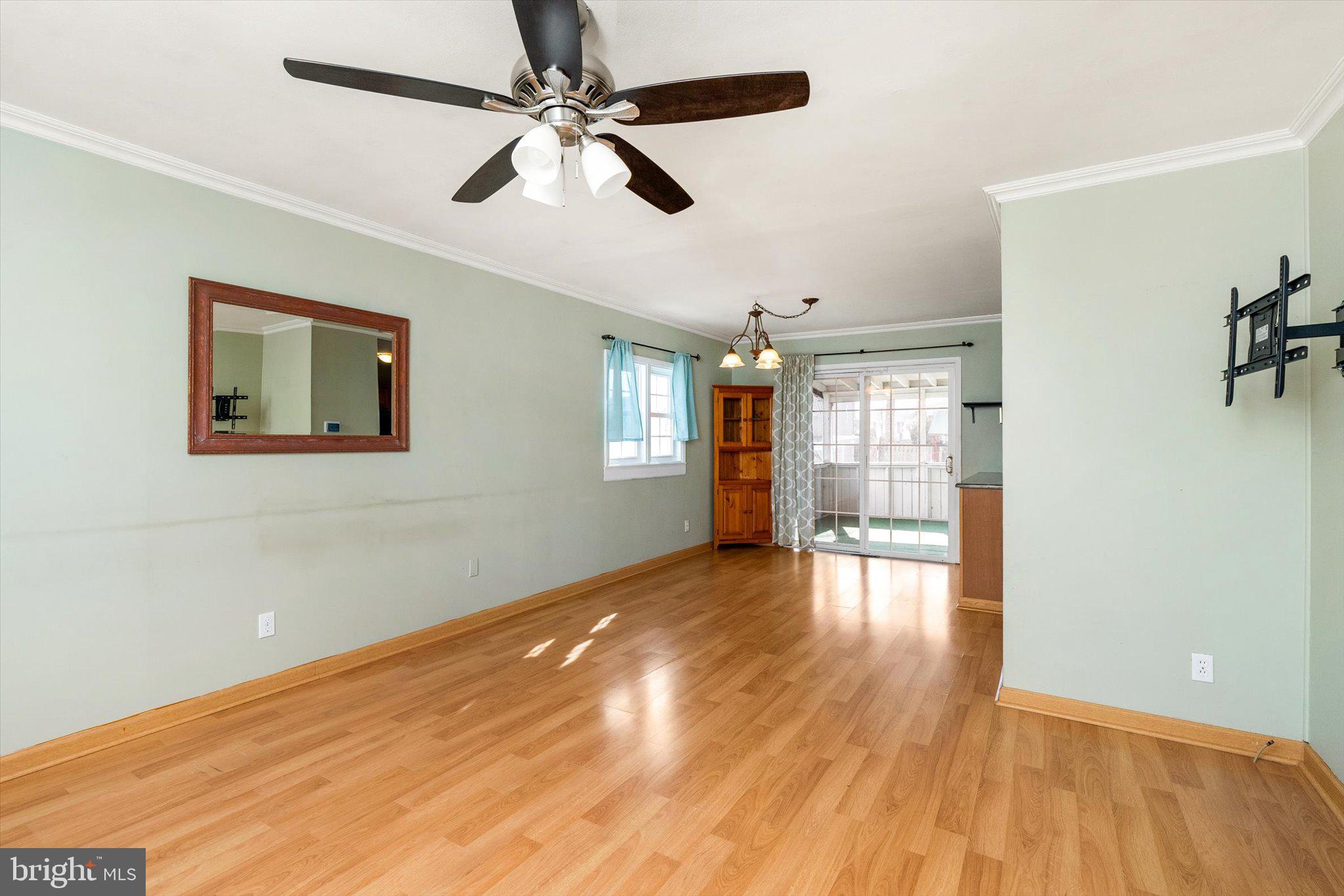 77 Gary Drive Hamilton, NJ 08690 - Photo 6 of 26 a view of an empty room with wooden floor and a ceiling fan