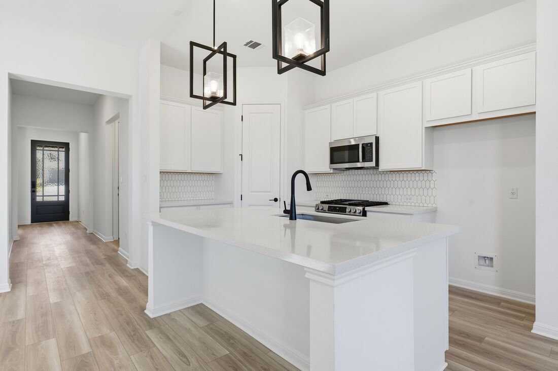 220 Wingstem Way Georgetown, TX 78633 - Photo 2 of 35 a kitchen with stainless steel appliances a sink stove and refrigerator