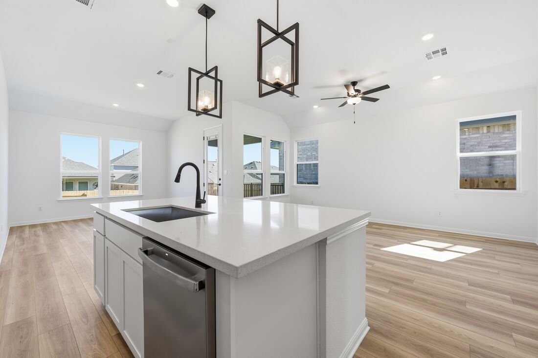 220 Wingstem Way Georgetown, TX 78633 - Photo 3 of 35 a kitchen with stainless steel appliances granite countertop a sink a stove and a wooden floors