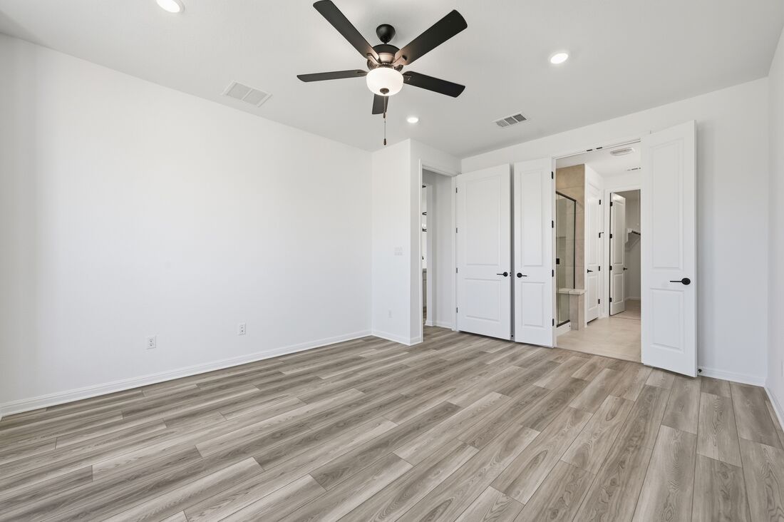 220 Wingstem Way Georgetown, TX 78633 - Photo 9 of 35 a view of an empty room with wooden floor