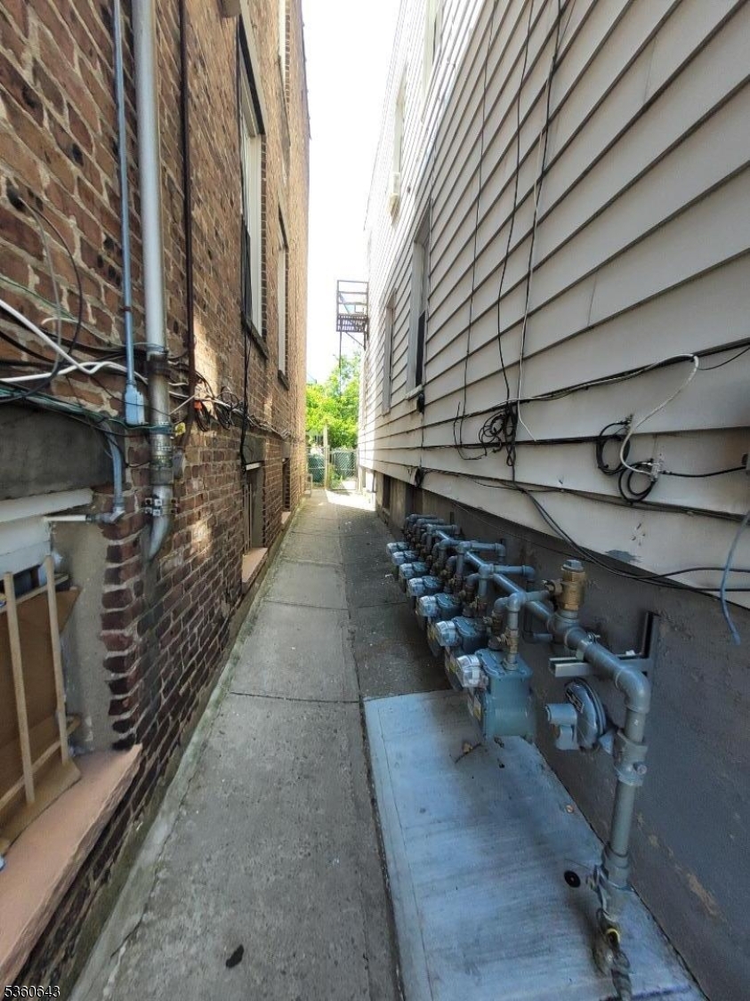 232 Niles Street Elizabeth, NJ 07202 - Photo 9 of 9 a view of a pathway with an empty room