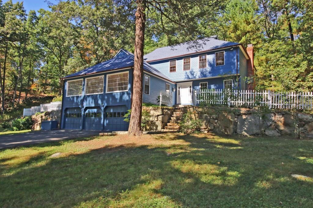 a view of a house with a yard patio and fire pit