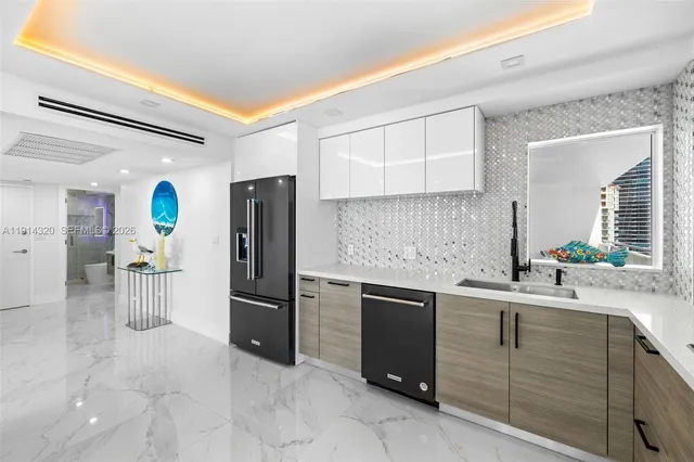 a kitchen with a sink and refrigerator