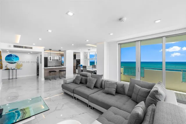 a living room with furniture and kitchen view