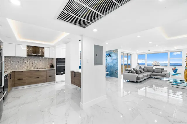 a large kitchen with a large window and stainless steel appliances