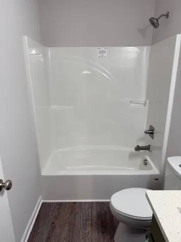 a bathroom with a toilet and a bath tub