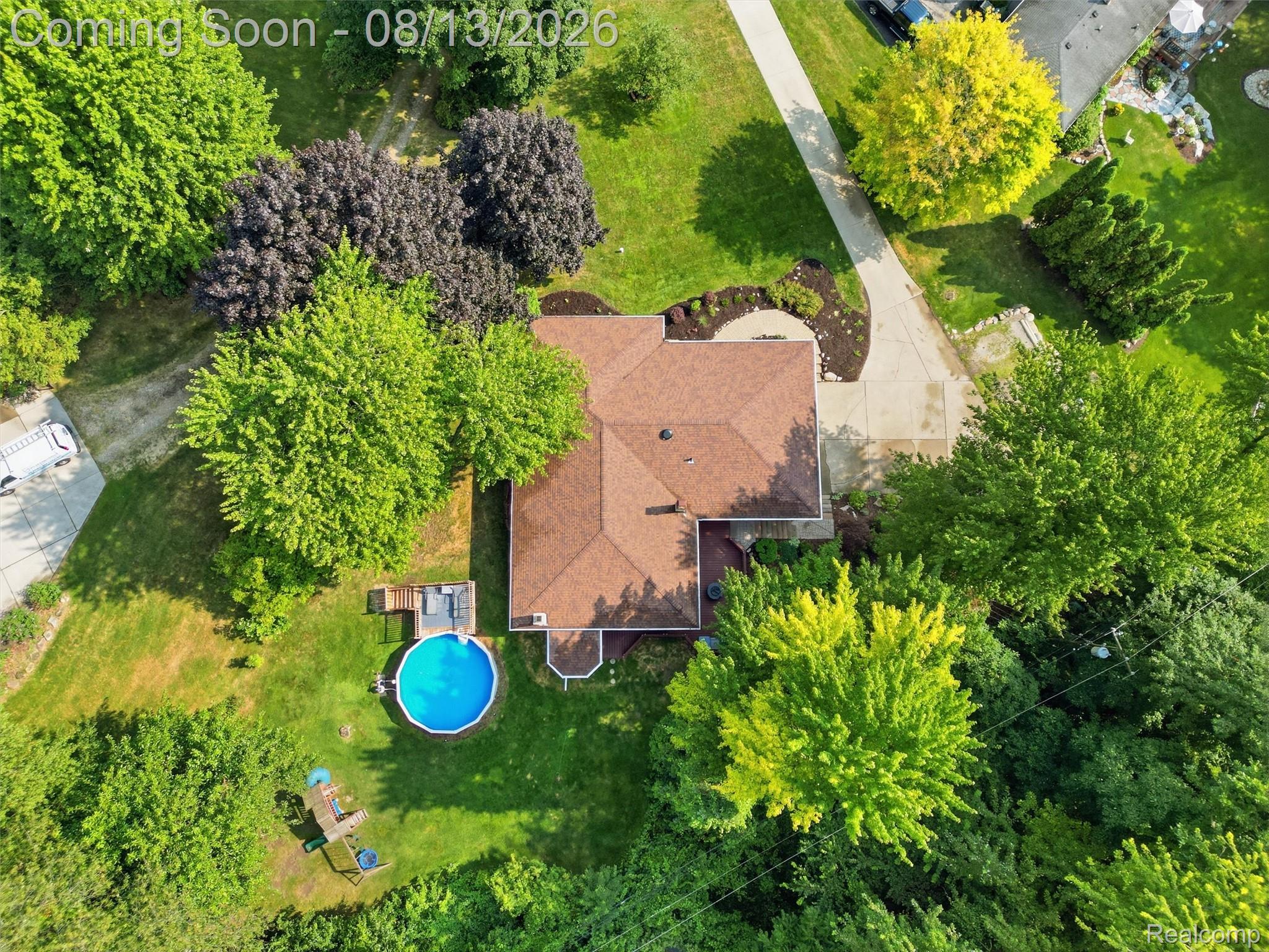 197 Perrydale Street Rochester, MI 48306 - Photo 46 of 50 Aerial view of this residential property showcasing a sprawling manicured lawn, mature tree-lined landscape, and a swimming pool