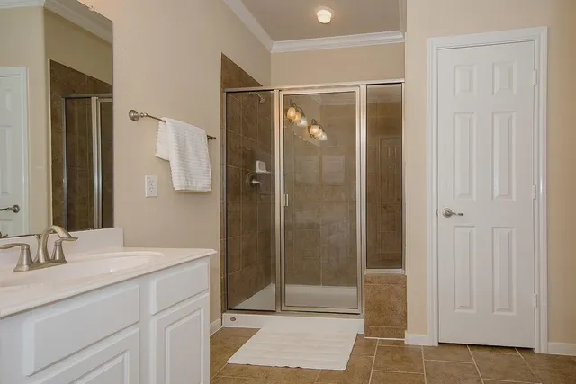 a bathroom with a shower and a sink
