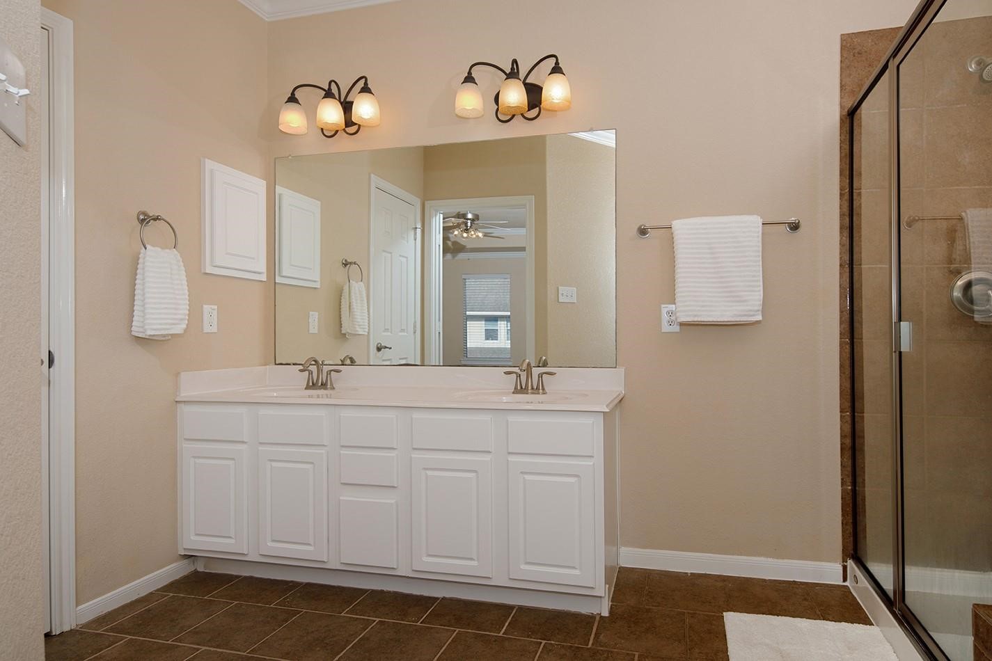 3 Pine Needle Place The Woodlands, TX 77382 - Photo 13 of 19 a bathroom with a sink and a mirror