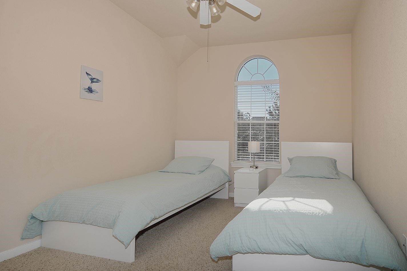3 Pine Needle Place The Woodlands, TX 77382 - Photo 14 of 19 a bedroom with a bed and a window