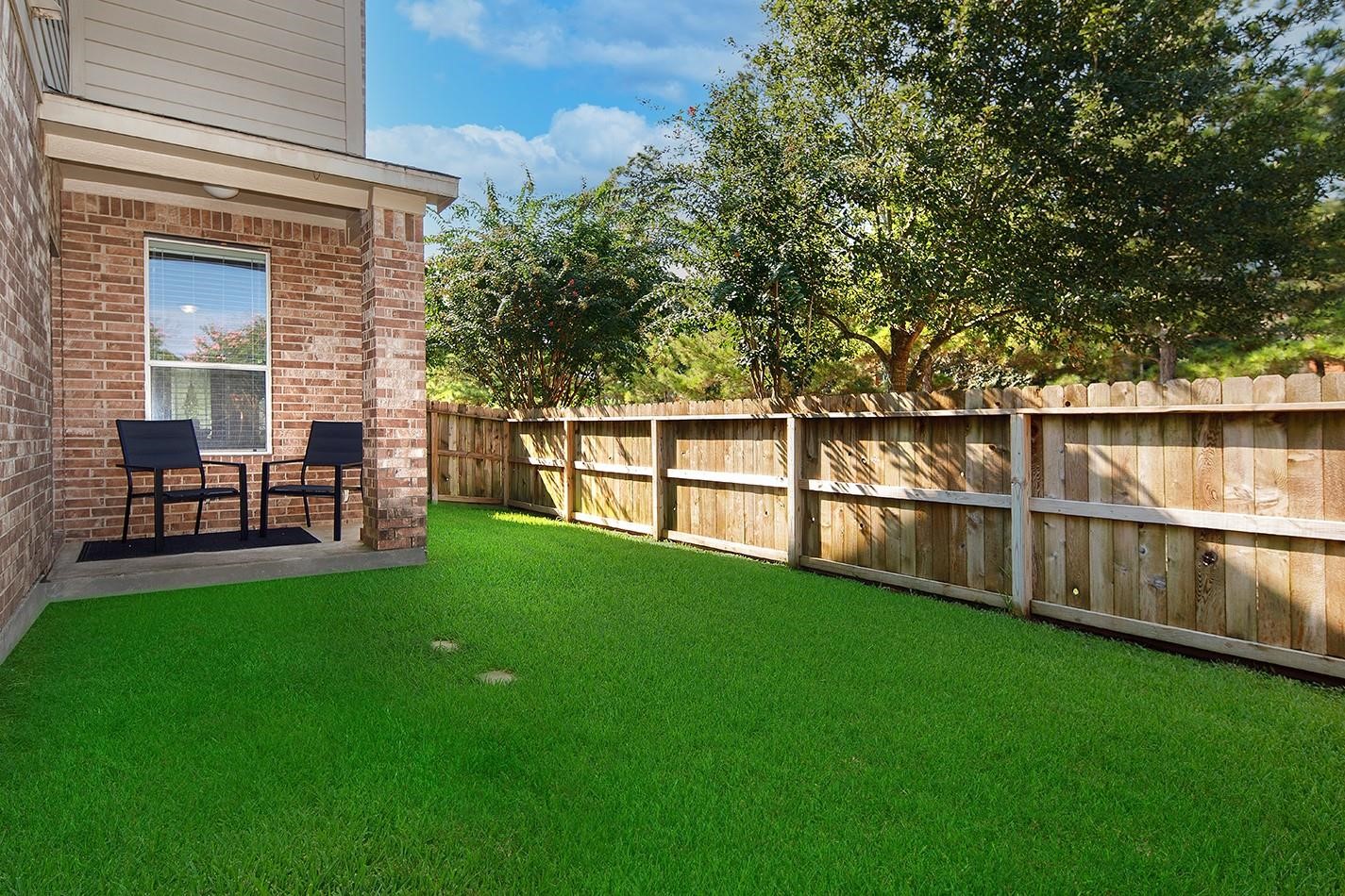 3 Pine Needle Place The Woodlands, TX 77382 - Photo 16 of 19 a view of backyard with seating and green space