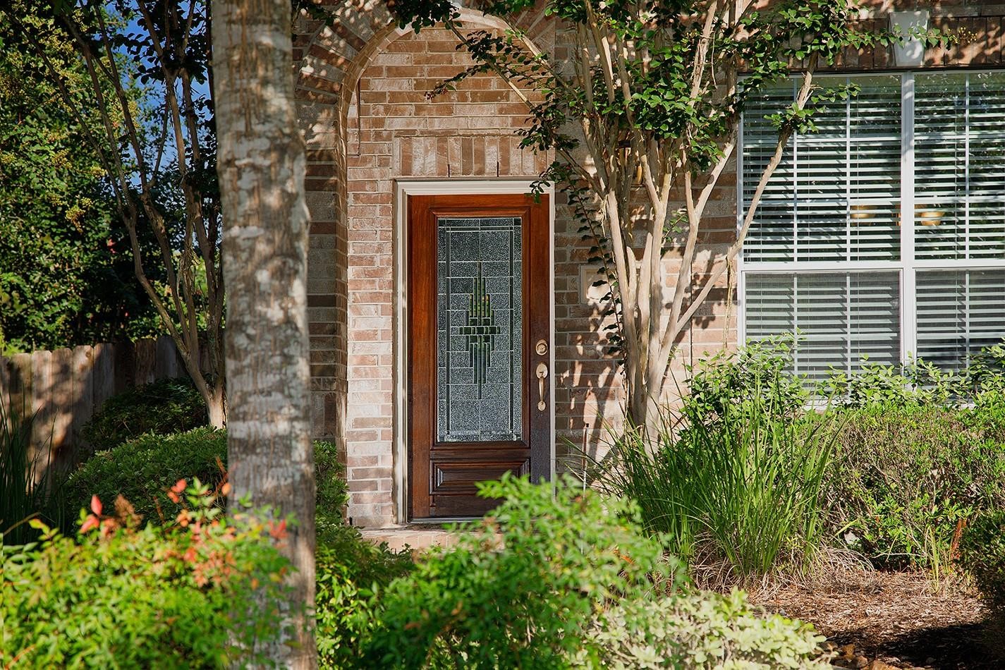 3 Pine Needle Place The Woodlands, TX 77382 - Photo 2 of 19 front view of a house with a garden