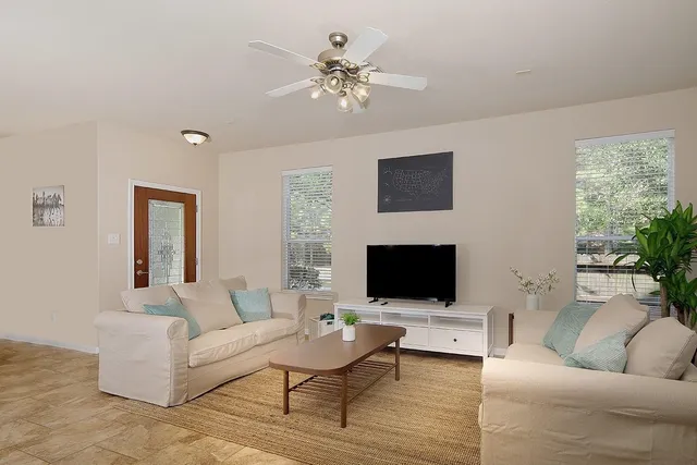 a living room with furniture and a flat screen tv
