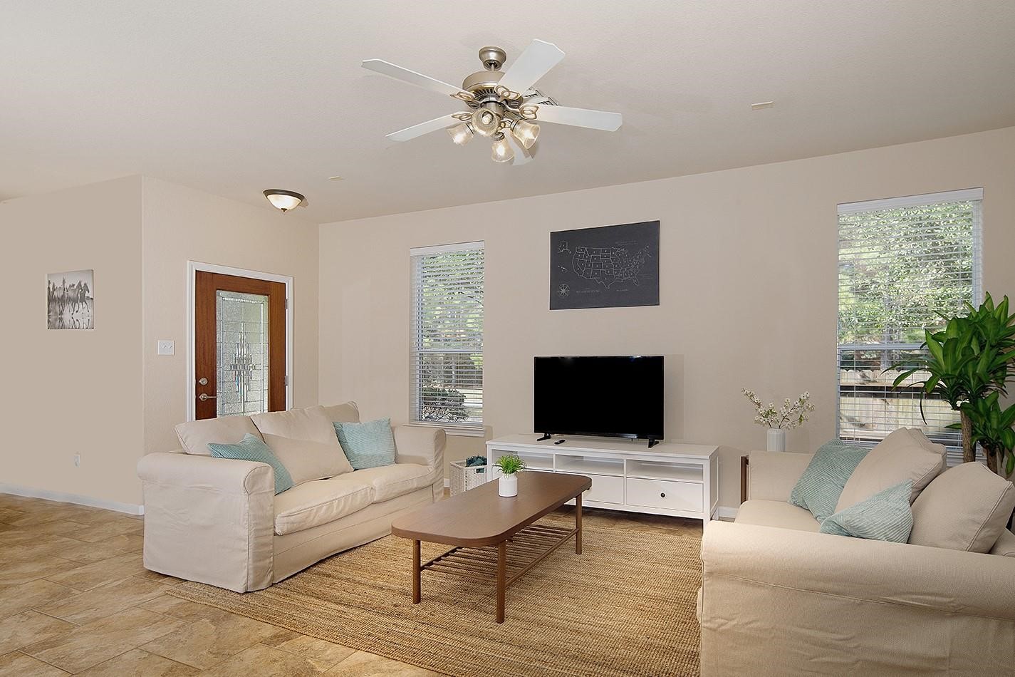 3 Pine Needle Place The Woodlands, TX 77382 - Photo 3 of 19 a living room with furniture and a flat screen tv