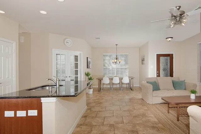 a living room with furniture and a chandelier