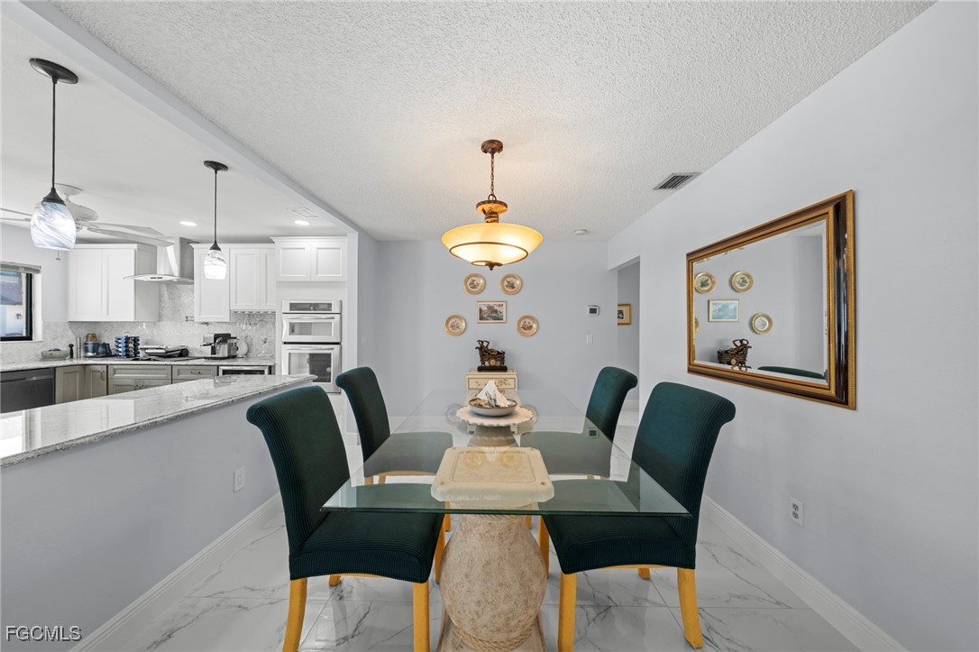 11650 Pointe Circle Fort Myers, FL 33908 - Photo 11 of 40 a view of a dining room with furniture window and wooden floor