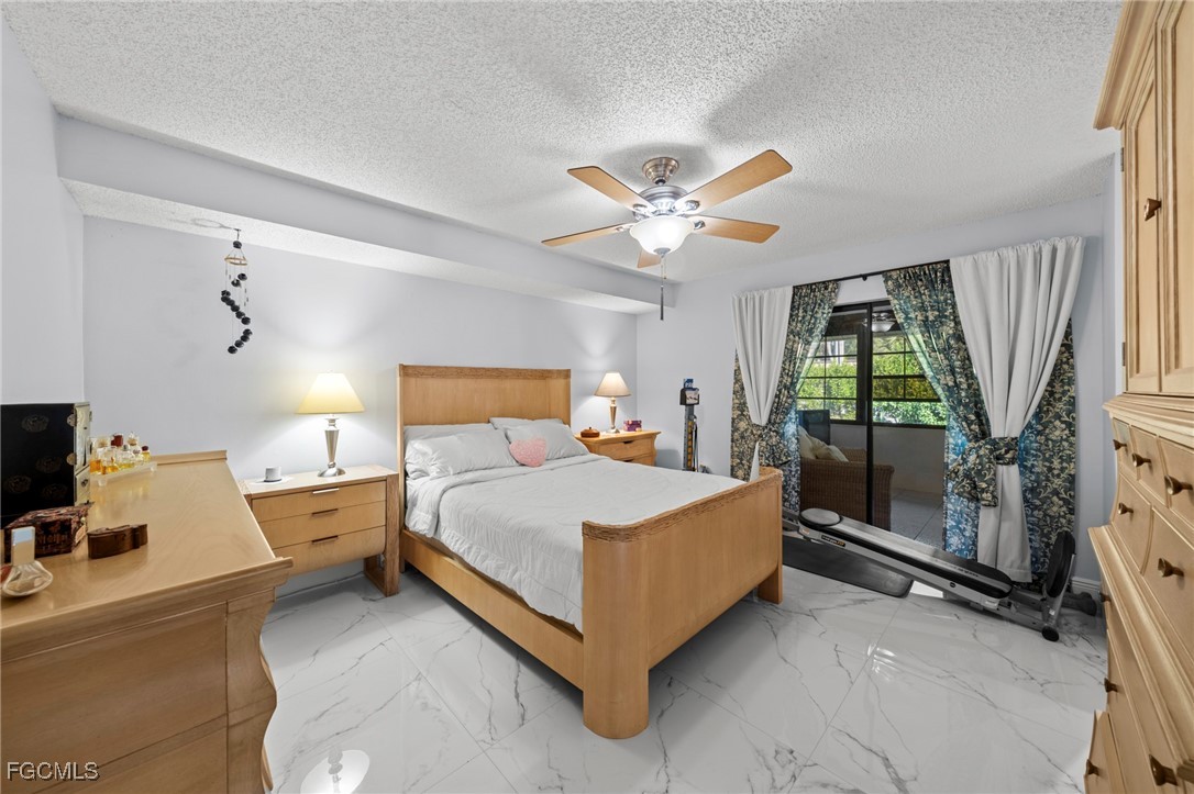 11650 Pointe Circle Fort Myers, FL 33908 - Photo 12 of 40 a bedroom with a bed and a large window