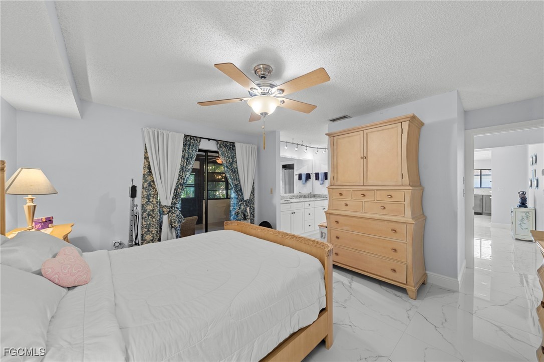 11650 Pointe Circle Fort Myers, FL 33908 - Photo 14 of 40 a bed room with a bed and a chandelier