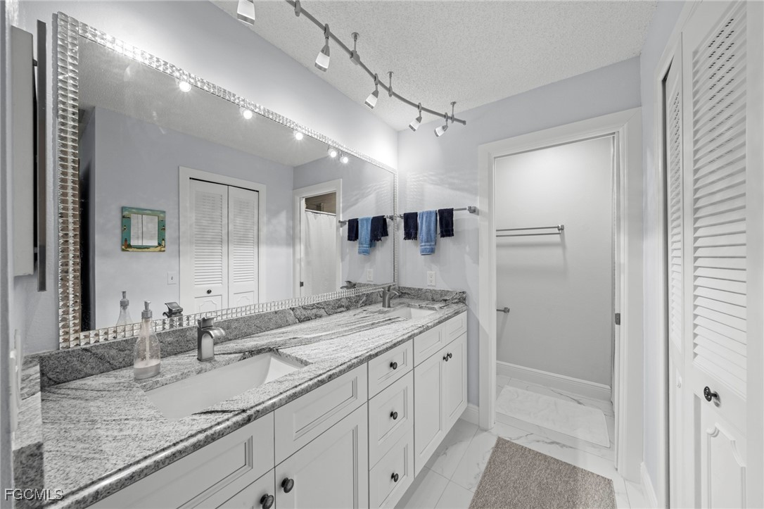 11650 Pointe Circle Fort Myers, FL 33908 - Photo 15 of 40 a bathroom with a granite countertop sink mirror and double