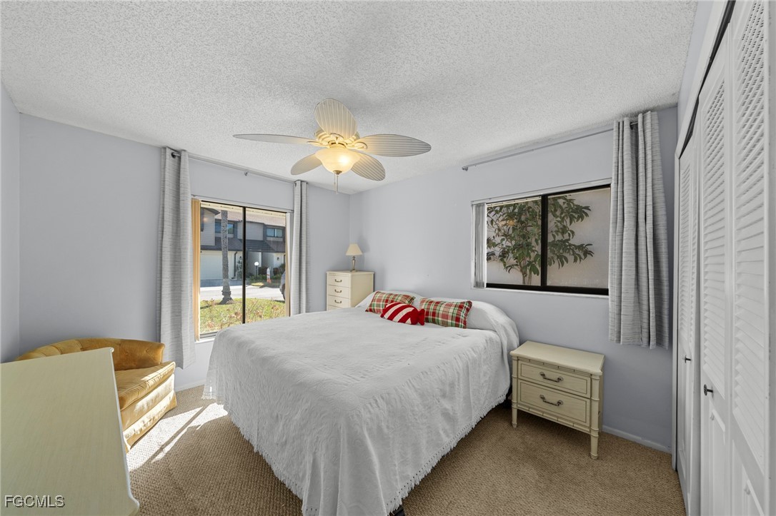 11650 Pointe Circle Fort Myers, FL 33908 - Photo 16 of 40 a bedroom with a bed and a chandelier